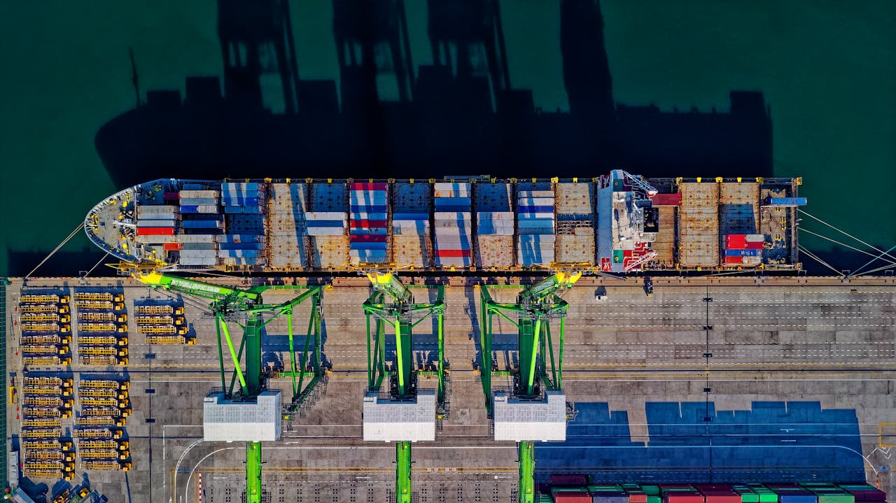 digital High angle aerial view of a cargo ship at a bustling port in Jakarta, showcasing global trade.