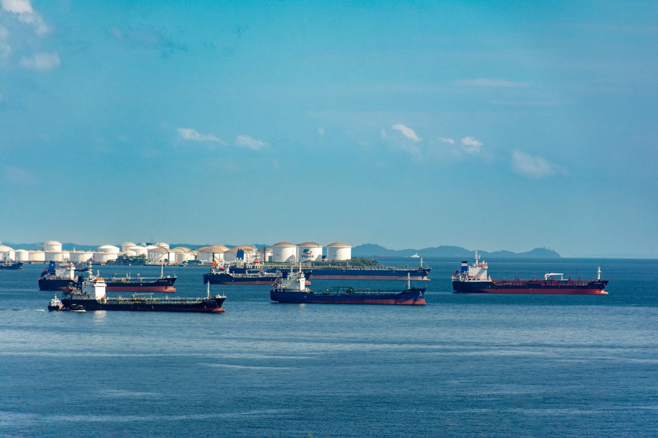 our-story cargo-ships-anchored-at-coastal-port-under-blue-sky-33284879