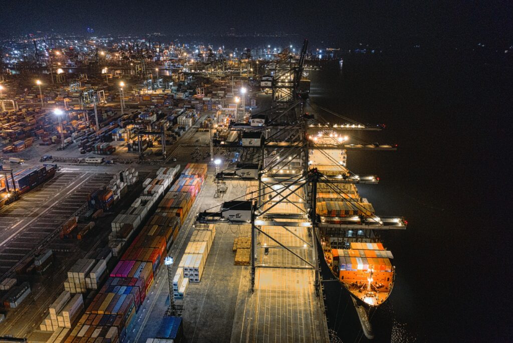 pexels photo 3075996 3075996 A captivating aerial view of Jakarta's bustling shipping port at night, showcasing vibrant activity.